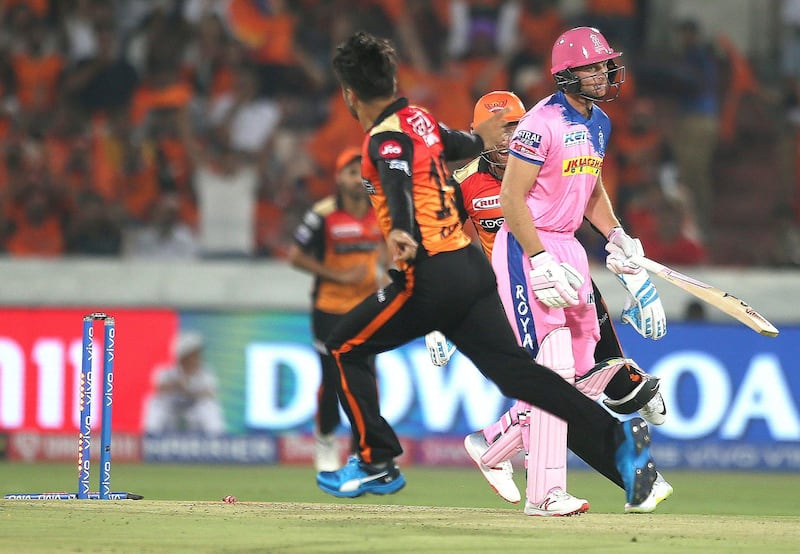 Rajasthan Royal's Jos Buttler, right, reacts after being dismissed by Sunrisers Hyderabad's Rashid Khan, left, during the VIVO IPL T20 cricket match between Sunrisers Hyderabad and Rajasthan Royals in Hyderabad, India, Friday, March 29, 2019. (AP Photo/ Mahesh Kumar A.)