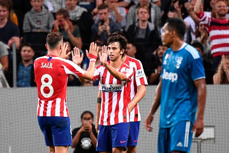 Joao Felix celebrates the first of his two goals against Juventus. AFP