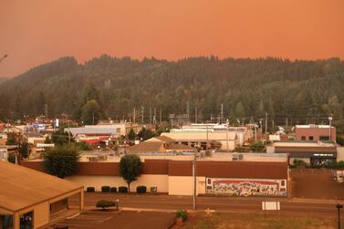 An orange smoke-filled sky is seen above the town of Estacada, Oregon, on September 9, 2020, as fires burn nearby. AFP