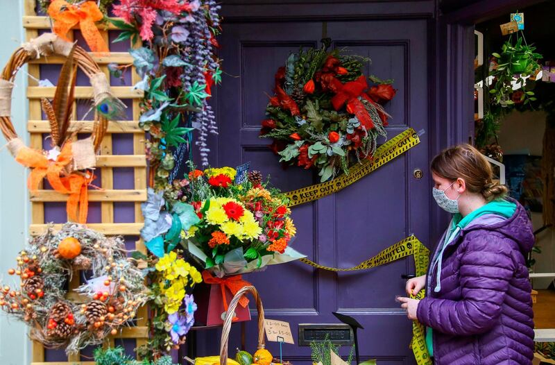 A member of staff at the Knighton Flower Box florists decorates the front of the shop. AFP