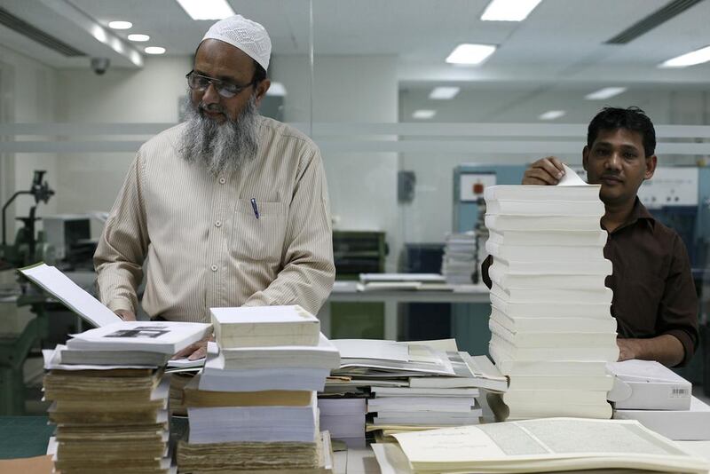 Employees of the Riyadh-based King Faisal Centre for Research and Islamic Studies in the think tank's book binding room. Justin Vela/The National