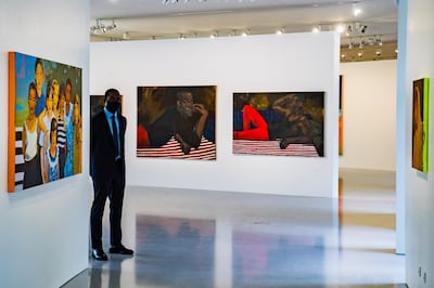 epa09206007 A man watches the room with paintings by British artist Lynette Yiadom-Boakye during the press visit of the 'Bourse de Commerce', a new venue dedicated to contemporary art created by French Businessman Francois Pinault in Paris, France, 14 May 2021 (issued 17 May 2021). The collection, an ensemble of over 10,000 works by almost 400 artists, features paintings, sculptures, videos, photographs, and installations and will be opened to public on 22 May 2021.  EPA/CHRISTOPHE PETIT TESSON