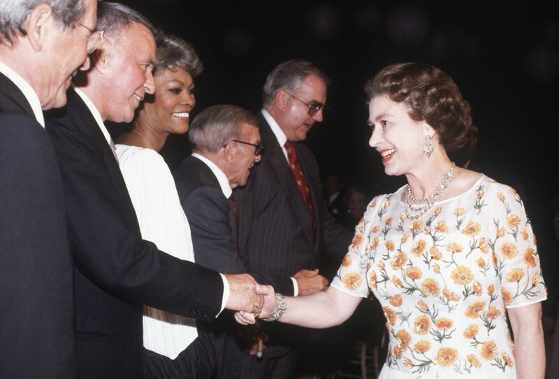 The queen meets singer Frank Sinatra as well as Perry Como, Dionne Warwick and George Burns in Long Beach, California, on February 27, 1983. Getty Images