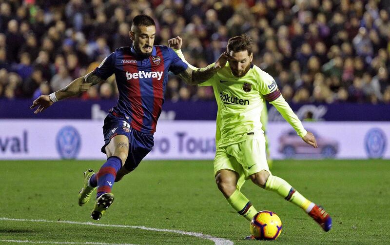 Lionel Messi in action against Levante's defender Erick Cabaco. EPA