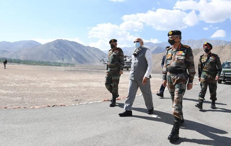 Army officials escort Mr Modi after his arrival in Leh, the capital of Ladakh.  EPA