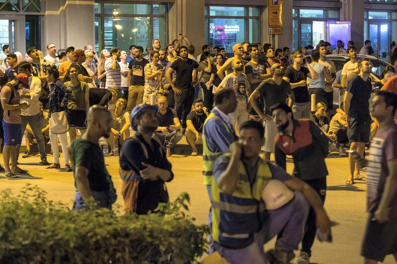 DUBAI. UNITED ARAB EMIRATES, 04 AUGUST 2017. A massive fire rips through The Marina Torch tower's southern corner. Crowds gathering on street level near the tower watch as the fire climbs up the side of the building. (Photo: Antonie Robertson) Journalist: None. Section: National.