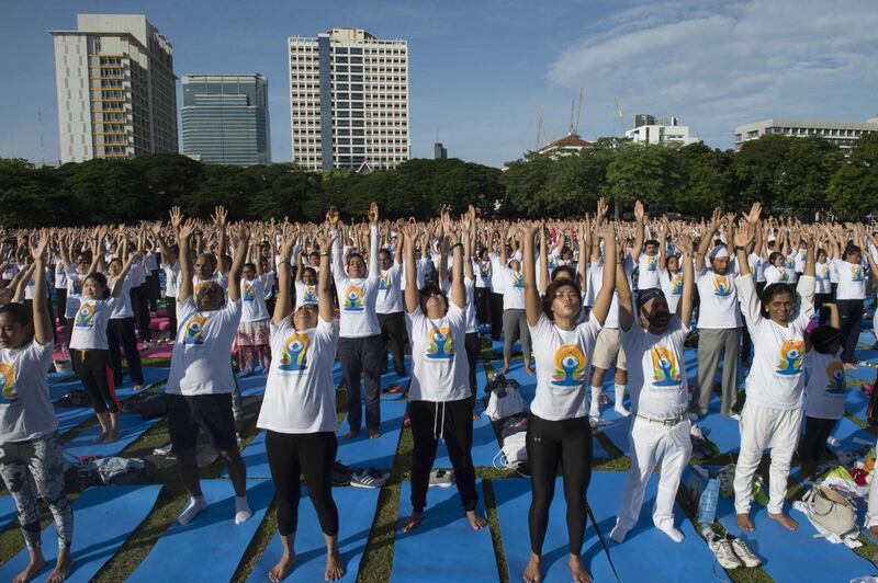 Hundreds of participants attend a mass yoga session at the grounds of Chulalongkorn University in Bangkok.  Romeo Gacad / AFP