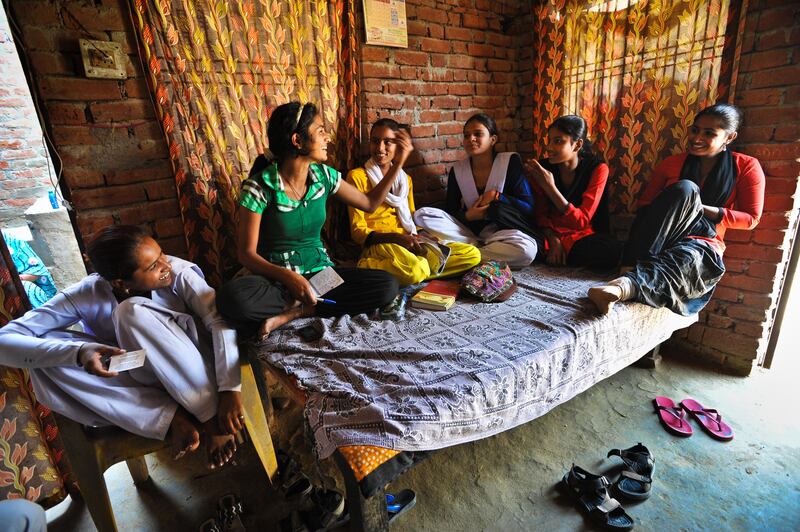 Members of the Red Brigade chat in the house of their leader, Usha Vishwakarma,. L-R. Laxmi, 16, Pooja Vishwakarma, 18, Kajil Sharma, 15, Afreen Khan, 16, Archana Kumari, 14, Usha Vishwakarma, 25. The Red Brigade was formed in November 2010 to fight back against a growing number of sexual attacks on women in the Madiyav area of the city of Lucknow, in Uttar Pradesh state, India.
The group of young women wear distinctive red and black salwar kameez. Most have been victims of sexual assault and have resolved that they will take no more. They take direct action against their tormentors and now when a local man steps out of line, he can expect a visit from the Red Brigade and a thrashing.