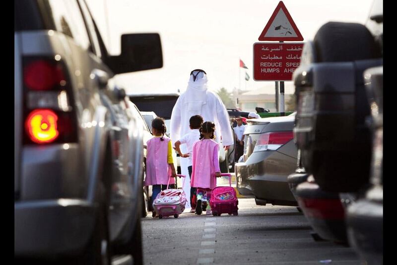 Students arrive to the Al Sanawbar School on the first day of the third term along Khalid bin Sultan street in Al Ain on April 8, 2012. Al Ain schools are testing a staggered start time as a way to reduce morning traffic and keeps kids safe. Christopher Pike / The National