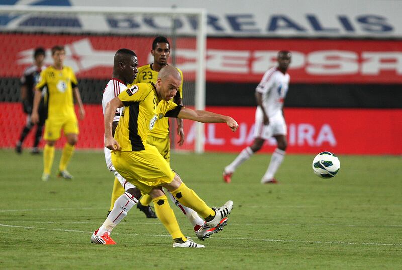 ABU DHABI , UNITED ARAB EMIRATES Ð Oct 15 : Mariano Donda ( no 8 in yellow ) of Al Wasl and Diaky Ibrahim ( no 10 in white ) of Al Jazira in action during the Etisalat Cup round 3 football match between Al Wasl vs Al Jazira at Mohammad Bin Zayed stadium in Abu Dhabi.  ( Pawan Singh / The National ) For Sports. Story by Amit