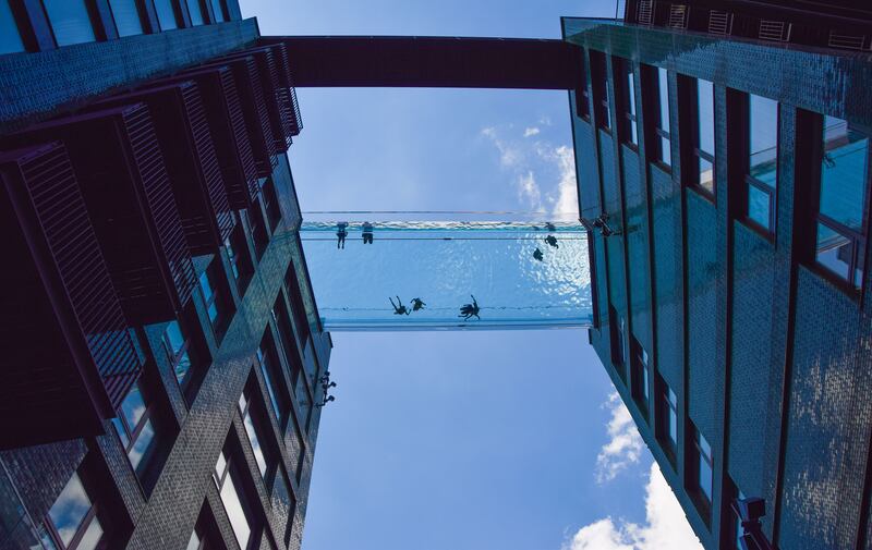 People swim in the Sky Pool, suspended 35 metres above the ground between two apartment buildings next to the US embassy, in 2021. Getty Images