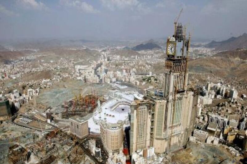 This aerial image made from a helicopter taken on Wednesday, Nov. 17, 2010, shows Muslim pilgrims moving around the Kaaba, the black cube seen at center, inside the Grand Mosque, during the annual Hajj in Mecca, Saudi Arabia. The skyscrapers, sporting towering glass facades and luxury shopping malls with international brands, have sprouted up in recent years around the esplanade in front of the sprawling, multi-level Haram Mosque. The mosque surrounds the Kaaba, the cube-shaped shrine that Muslims around the world face during prayers and pilgrims circle seven times during the hajj rites. (AP Photo/Hassan Ammar) *** Local Caption ***  HAS115_Saudi-Hajj.jpg