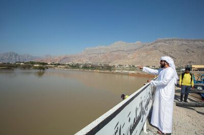 RAS AL KHAIMAH, UNITED ARAB EMIRATES- Mohammad a resident of RAK is showing the how high was the flood was at Ghalilah cemetery  due to rain from last Saturday.  Leslie Pableo for The National for Ruba Haza's story