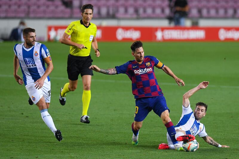 Lionel Messi competes for the ball with David Lopez. Getty Images