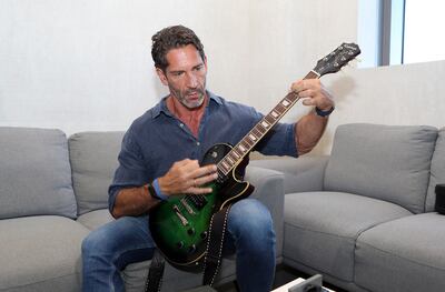 In his spare time, Dr Dmitri practices guitar in his office at the Wellfit branch in Meydan. Pawan Singh / The National