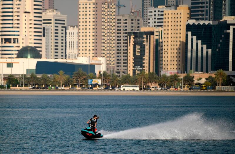 A woman rides a jet ski at al-Mamzar district in Dubai. AFP