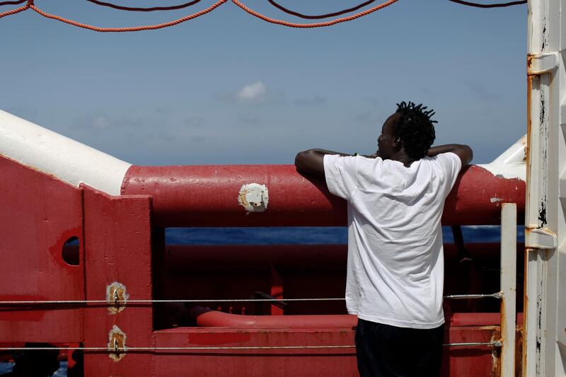 A man looks at the horizon from the Ocean Viking in Mediterranean Sea, Tuesday, Sept. 10, 2019. The humanitarian rescue ship operated by SOS Mediterranee and Doctors Without Borders, has requested Italian and Maltese authorities for the medical evacuation of a pregnant woman and a place of safety for the other 83 rescued migrants. (AP Photo/Renata Brito)