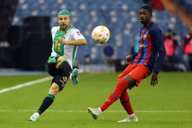 Real Betis' Spanish forward Aitor Ruibal battles with Barca's French forward Ousmane Dembele. AFP