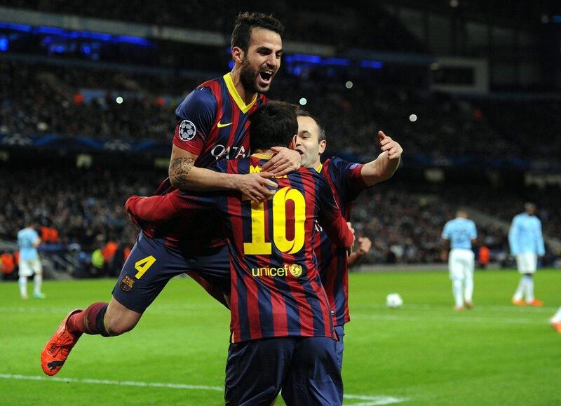 Lionel Messi and Cesc Fabregas celebrate after Barca's first goal on Tuesday night. Peter Powell / EPA  