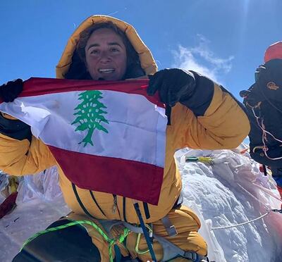 Fatima Deryan unfurls the Lebanese flag at the summit of Everest