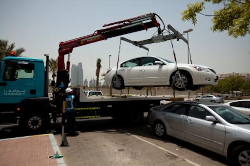 ABU DHABI, UAE - July 20, 2011- Mawaqif performs a demonstration of how to tow a car at the Department of Transportation in Abu Dhabi.  (Andrew Henderson / The National) 