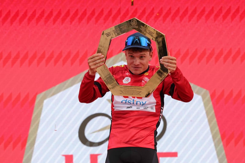 Lotto-DSTNY's Lennert Van Eetvelt celebrates with the trophy after winning the UAE Tour. AFP