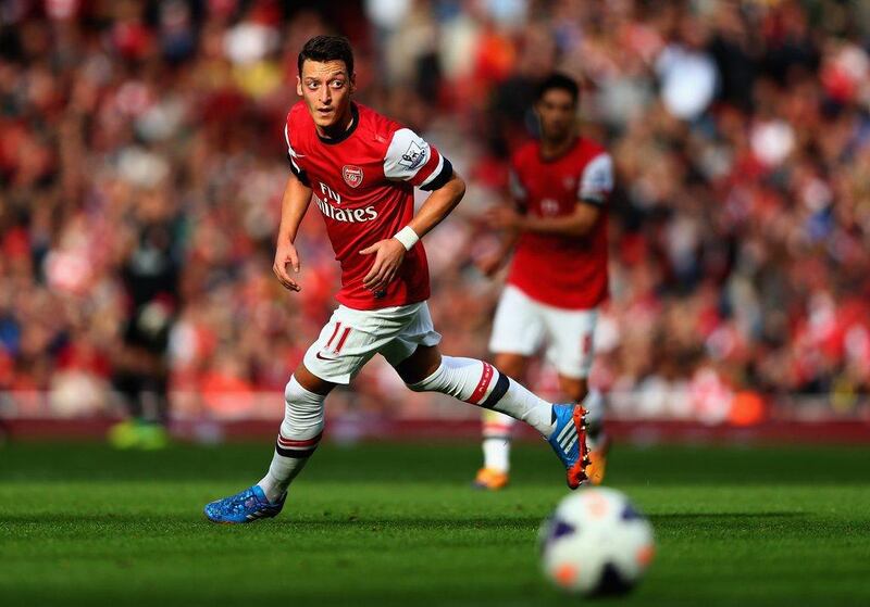 Arsenal centre forward Mesut Ozil was signed to create goals but chipped in with two, including a rare header, against Norwich. Paul Gilham / Getty Images