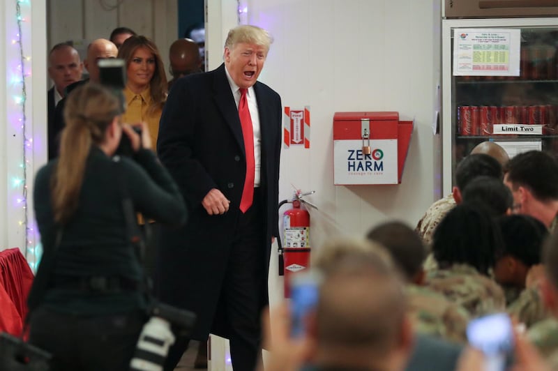 US President Donald Trump and first lady Melania Trump arrive to greet military personnel at the dining facility during an unannounced visit to Al Asad Air Base, Iraq. Reuters