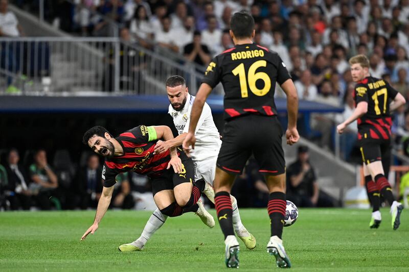 Manchester City's Ilkay Gundogan tangles with Real Madrid's Dani Carvajal. AFP