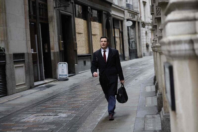 A pedestrian walks in the City of London on December 11, 2020.  A Brexit trade deal between Britain and the European Union looked to be hanging in the balance on Friday, after leaders on both sides of the Channel gave a gloomy assessment of progress in last-gasp talks. The Bank of England said Friday that UK banks remained "resilient" to the risks of Brexit and coronavirus, but warned financial services could face "disruption" when the transition period ends. / AFP / Tolga Akmen
