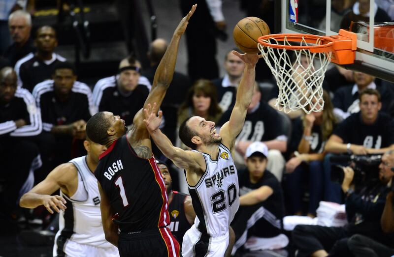 Manu Ginobili of the San Antonio Spurs scores under pressure from Chris Bosh of the Miami Heat during game 5 of the NBA finals on June 16, 2013 in San Antonio, Texas., where the Spurs defeated the Heat 114-104 and now lead the series 3-2. AFP PHOTO/Frederic J. BROWN
 *** Local Caption ***  359768-01-08.jpg