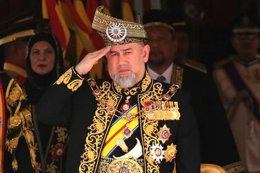 Sultan Muhammad V salutes during the national anthem at the opening of parliament. AP