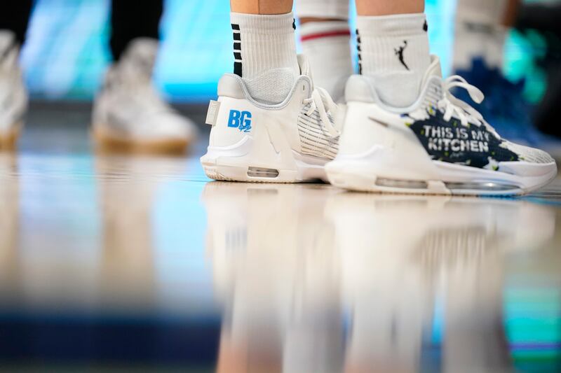 Dallas Wings' Marina Mabrey wears shoes that have a "BG" logo on them, a reference to Brittney Griner, during the second half of the team's WNBA basketball game against the Indiana Fever, Thursday, June 23, 2022, in Arlington, Texas. AP