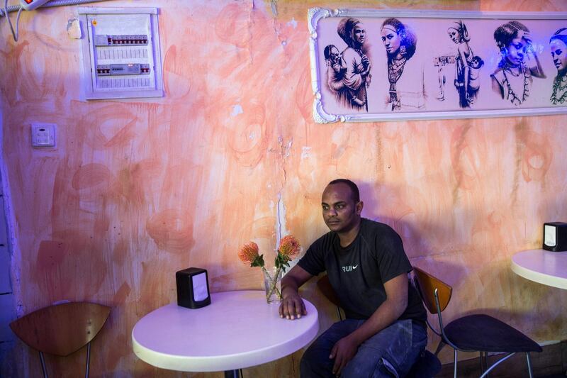 Michael Avraham,28, from Eritrea as he sits at a table at the Harhara café in south Tel Aviv on March 19,2018. "It's not everyone, but there are a lot of racists here," said  Avraham .(Photo by Heidi Levine for The National).