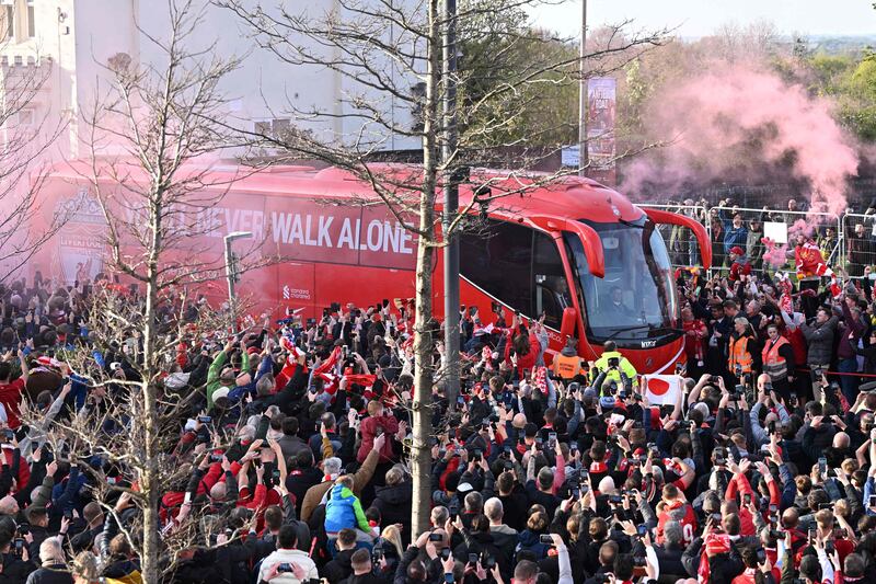 Liverpool's fans cheer as their team bus arrives. AFP