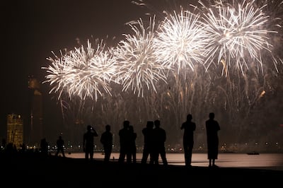 Abu Dhabi, Dec. 2/13-People watch the fireworks along the corniche in Abu Dhabi Monday evening. (Silvia Razgova / The National) *** Local Caption ***  SR022013-2544.JPG
