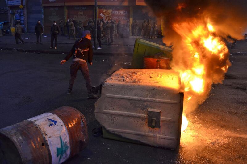 Lebanese anti-government protesters burn dumpsters to block al-Nour Square in Lebanon's northern port city of Tripoli. AFP
