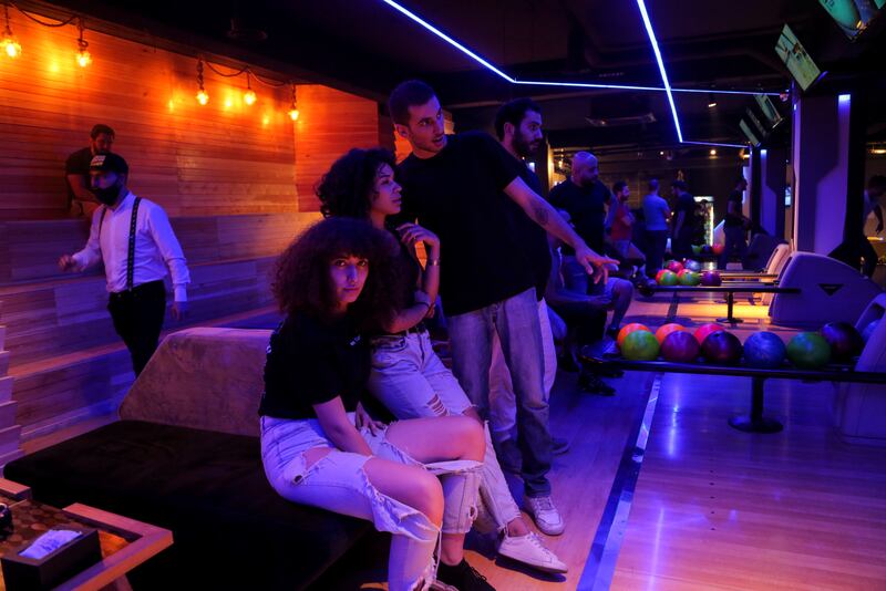 Ghenwa, 20, a trainee flight attendant, Souna, 25, a business manager, Karam, 23, a DJ, and Ali, 24, an IT student, go bowling in Damascus, Syria. More than two thirds of young Syrians believe their best days are ahead of them, up from 12 per cent in 2020. Photo: Yamam Al Shaar / Reuters