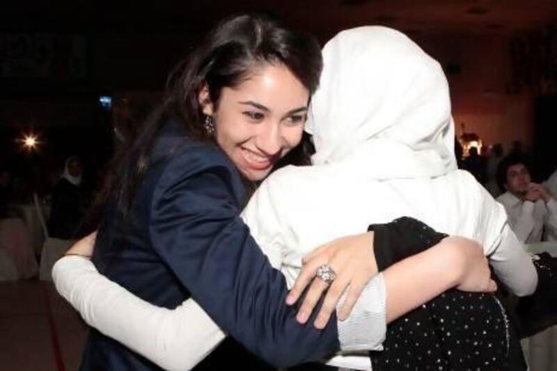 Nassim Oroumchian, left, who won Best Supporting Actress, embraces a colleague as A Second Look wins The Best Overall Film award at the GEMS Student Voice Videos at Al Khaleej National School. Jeffrey E Biteng / The National