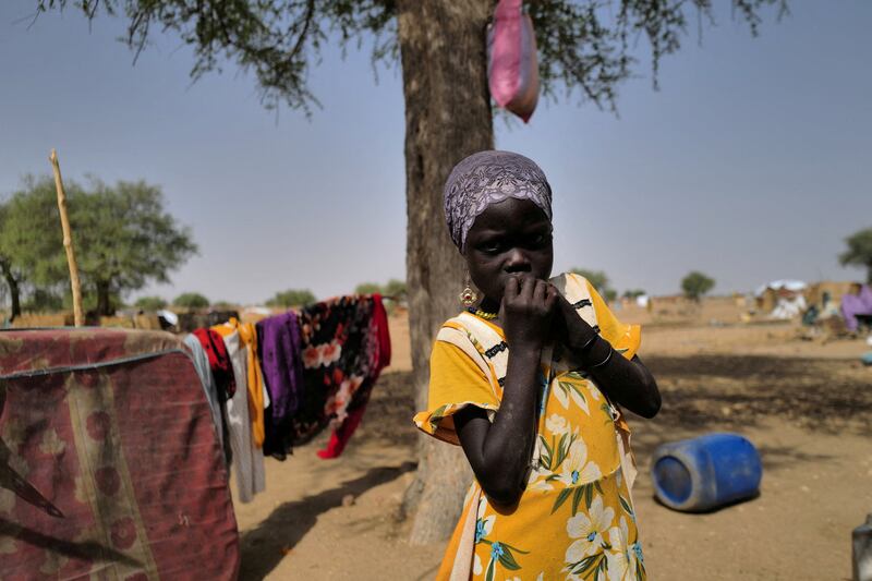 A Sudanese refugee who has fled the violence in Sudan's Darfur region stands by her shelter near the border between Sudan and Chad. Reuters