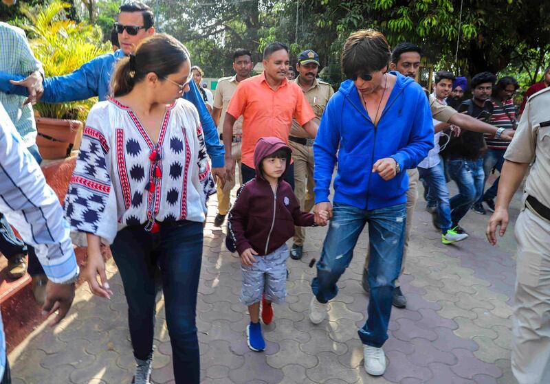 Bollywood actor Shah Rukh Khan and producer wife, Gauri Khan, arrive at a polling station in Mumbai on April 29, 2019 with son, AbRam Khan. AFP