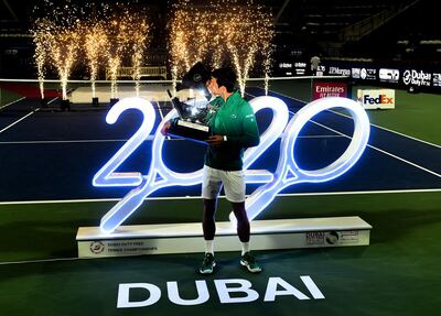 DUBAI, UNITED ARAB EMIRATES - FEBRUARY 29: Novak Djokovic of Serbia celebrates with the trophy after winning his men's final match against Stefanos Tsitsipas of Greece on Day 13 of the Dubai Duty Free Tennis at Dubai Duty Free Tennis Stadium on February 29, 2020 in Dubai, United Arab Emirates (Photo by Tom Dulat/Getty Images)