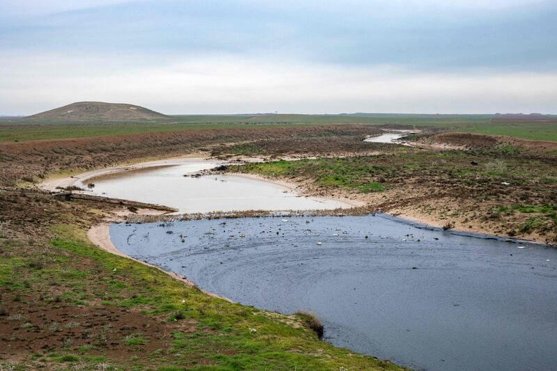 An oil spill pollutes a stream near Qamishli in Syria's north-eastern provice of Hasakah. AFP