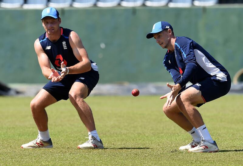England's captain Joe Root (R) takes a catch as Jos Buttler looks on during a practice session at the Sinhalese Sports Club (SSC) Ground in Colombo on November 21, 2018. The third and final Test between England and Sri Lanka will be played on November 23, 2018, at the Sinhalese Sports Club (SSC) international cricket stadium in Colombo. / AFP / ISHARA S.  KODIKARA
