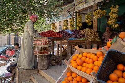 An Egyptian arranges fruits at a shop in Cairo, Egypt. AFP