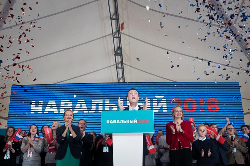 Russian opposition leader Alexei Navalny, center, gestures while speaking during his supporters' meeting that nominated him for the presidential election race in Moscow, Russia, Sunday, Dec. 24, 2017. His wife Yulia is on the left. The 41-year-old anti-corruption crusader has run a yearlong grass-roots campaign and staged waves of rallies to push the Kremlin to let him run. (AP Photo/Pavel Golovkin)