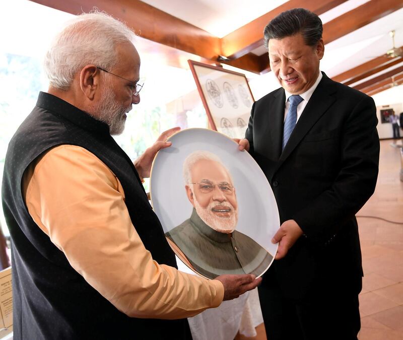 India's Prime Minister Narendra Modi and China's President Xi Jinping exchange gifts. Reuters