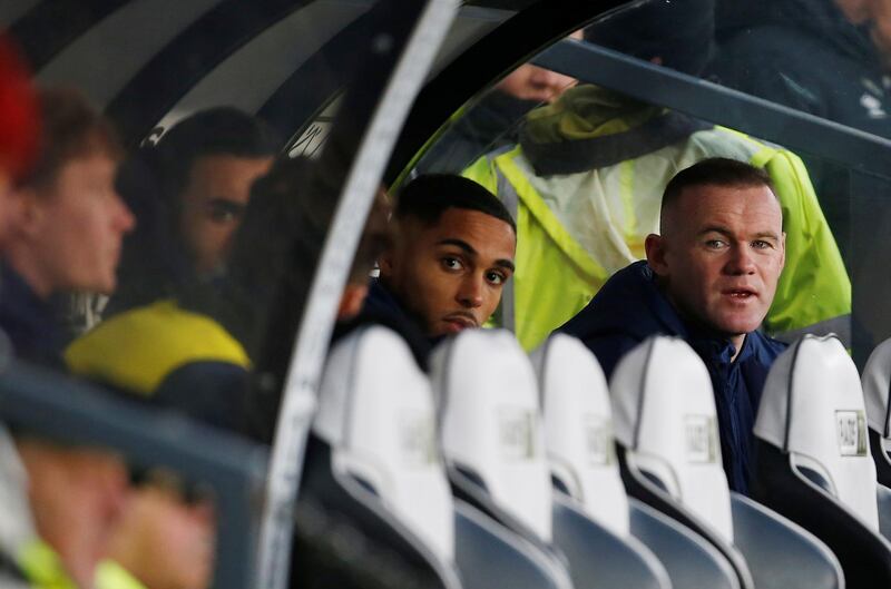 Wayne Rooney watches the Derby v QPR match from the dugout. Reuters