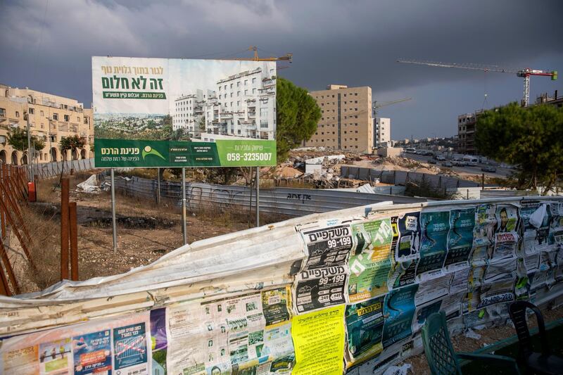 FILE - In this Nov. 10, 2020 file photo, a billboard advertises a new residential project at a construction site in the east Jerusalem Israeli settlement of Ramat Shlomo. Israel said Thursday, April 8, 2021, it will formally reject the International Criminal Courtâ€™s decision to launch a probe into potential war crimes against the Palestinians. The court is expected to look at possible war crimes committed by Israelis forces and Palestinian militants during and after the 2014 Gaza war, as well as Israelâ€™s settlements in the West Bank and east Jerusalem. (AP Photo/Ariel Schalit, File)