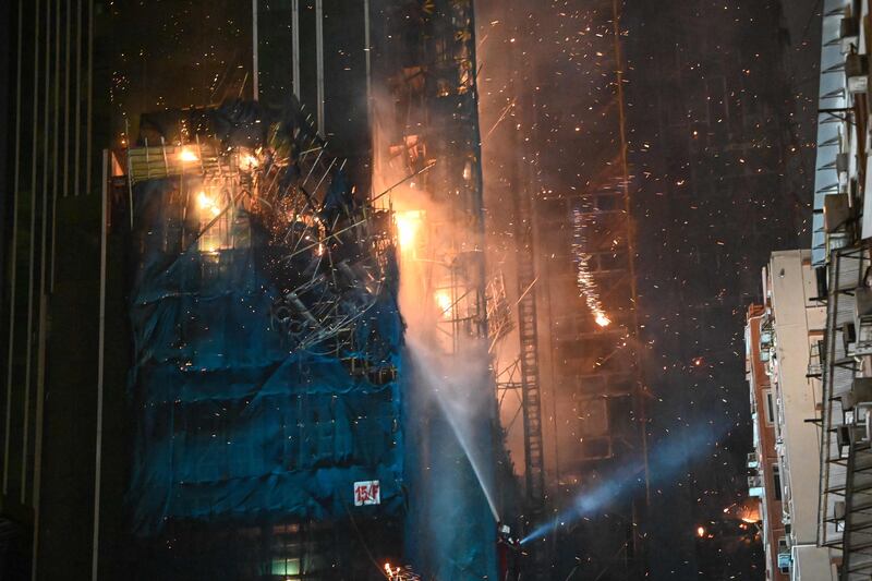 Burning debris falling from the under-construction building on fire. AFP